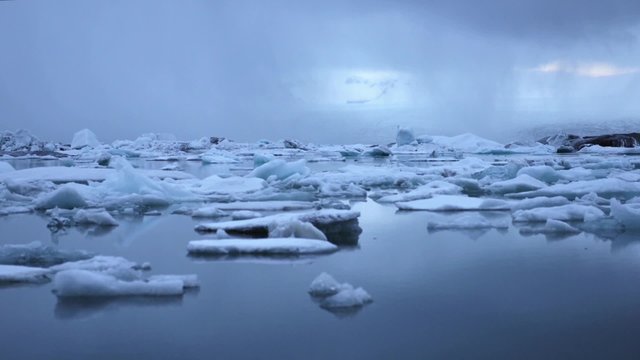 Blue icebergs floating on Jokunsarlon glacial lagoon