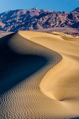 Fototapeta na wymiar sand dune with ripples and mountains