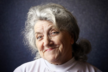 Happy granny portrait on a dark background