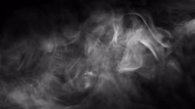 Smoky fog rises up into a beam of light.  Recorded against a black background and intended as a stand alone shot or for compositing using a blending mode.  Looping clip.