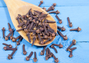 Cloves on a blue board.