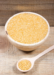 Brown sugar cane on the wooden background.