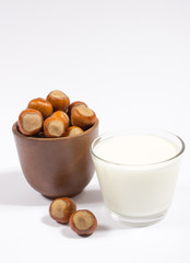 Glass of hazelnut milk isolated on white background.
