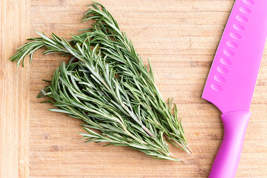 Fresh rosemary on a wooden chopping board