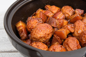Vietnamese caramelized pork belly with deep fried eggs  in clay
