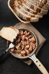 Pieces of sausage fried with onions