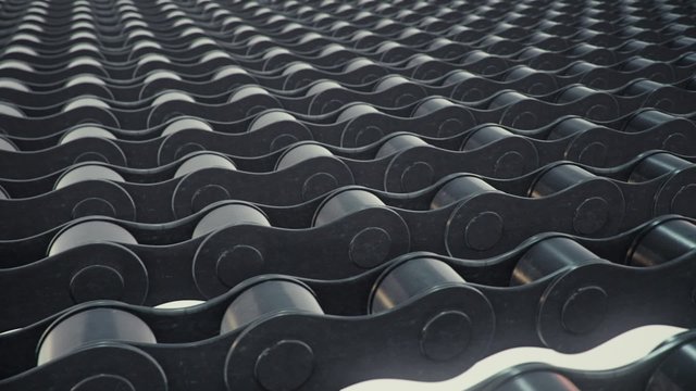 An endless array of bike chain links travelling across the frame.