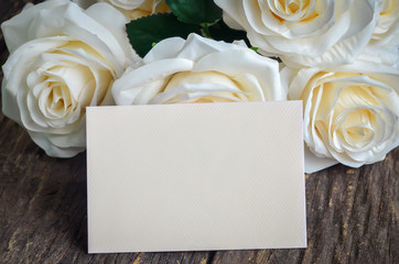 Blank greeting card with white artificial rose