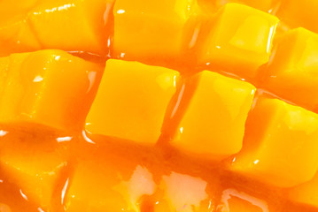 King of fruits; close-up of Alphonso yellow Mango fruit juicy cubes on mango pulp thick juice