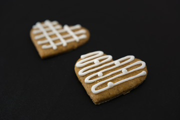 Two gingerbread hearts lying side by side