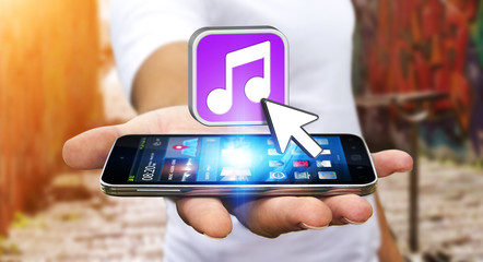 Young man using modern mobile phone to listen music