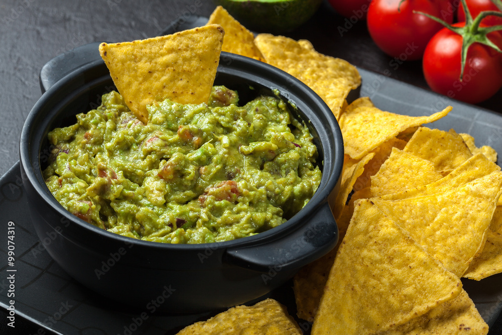 Wall mural Bowl of guacamole with corn chips