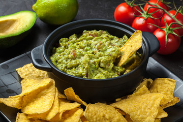 Bowl of guacamole with corn chips