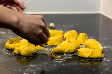 Making yellow saffron buns at the bakery