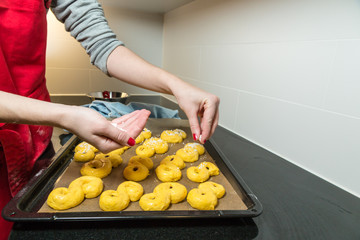 Garnishing the saffron buns with granulated sugar