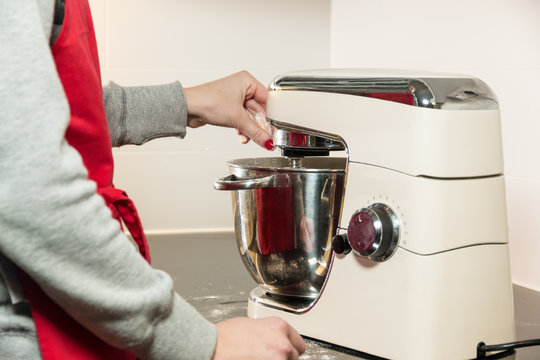 Working with the bread maker in clean kitchen