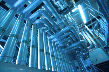 Equipment, cables and piping as found inside of a modern industr