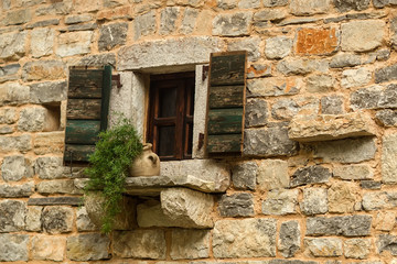 Fototapeta na wymiar Open window with wooden shutters