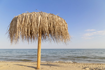 Fototapeta na wymiar Umbrella on the empty beach in summer