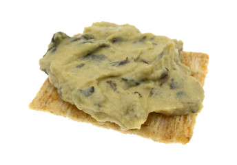 Spinach hommus on whole grain cracker