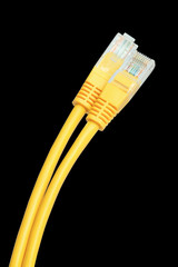 Yellow Network Cable plug isolated against black background.