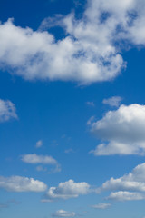 Naklejka na ściany i meble Cloudscape over horizon. Blue sky and white clouds.