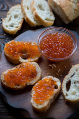 Fototapeta na wymiar Closeup of sandwiches with salmon red caviar, selective focus