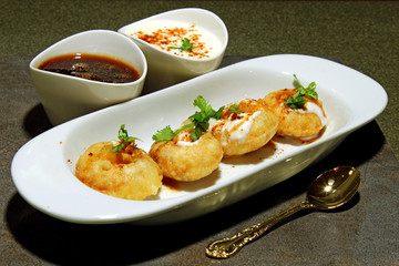 Panipuri or Gol Gappa or Chaat, Indian Street Food, Panipuri, Golgappe, Chat item, India, Stuffed Panipuri with aloo and Sweet Tamarind - Indian Food © Dipali S