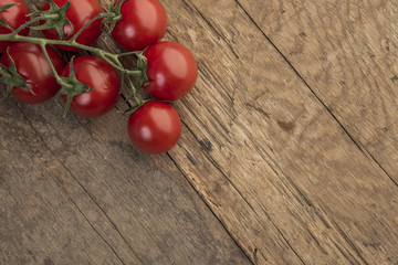 ripe cherry tomatoes on wooden background