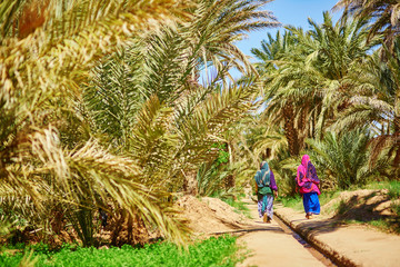 Two berber women in oasis of Merzouga village in Sahara desert, Morocco