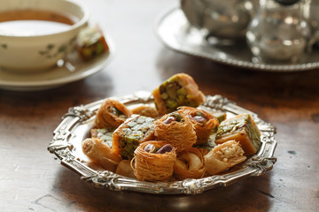 Syrian pastry with pistachios and nuts and a cup of tea