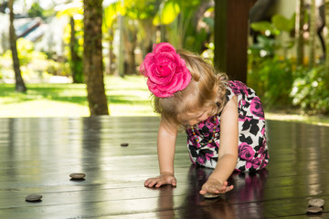 Adorable little child girl . Summer green nature background.  Use it for baby, parenting or love concept