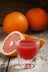 Juice of red Sicilian oranges in a large glass, selective focus