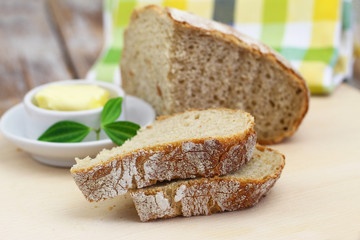 Slices of traditional rustic rye bread on wooden board
