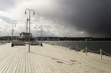 rain passing over a wooden, sea pier