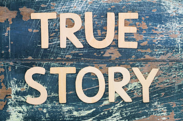 True story written with wooden letters on rustic surface
