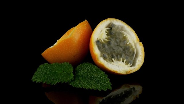 Passion fruit maracuja granadilla on black background.