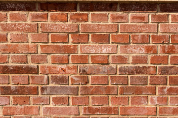red-orange brick wall with shadows