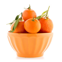 Tangerines on ceramic orange bowl