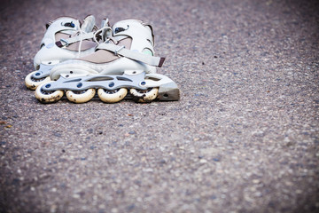 Closeup roller skates on asphalt.