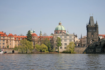 Obraz premium PRAGUE, CZECH REPUBLIC - APRIL 24, 2010: River Vltava in Prague. Old Town tower of Charles bridge and St Francis' of Assisi Church near the river.
