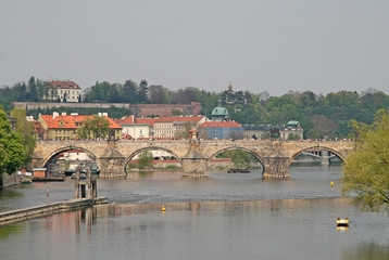 PRAGUE, CZECH REPUBLIC - APRIL 28, 2010: Charles bridge crossing the Vltava river in Prague, Czech...