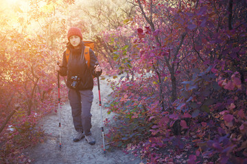 A girl with a camera and a backpack