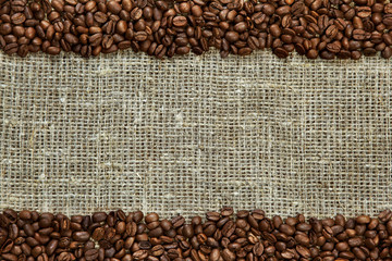 Coffee beans on burlap background.