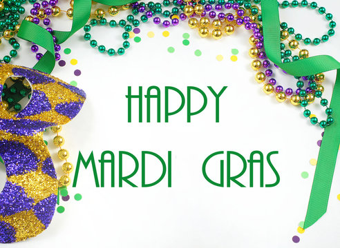 Mardi Gras image of harlequin mask, beads, ribbon and confetti in gold, green and purple