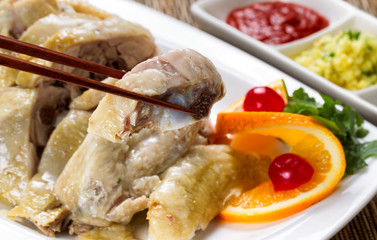 Sliced chicken and dipping sauces on white serving plate ready t