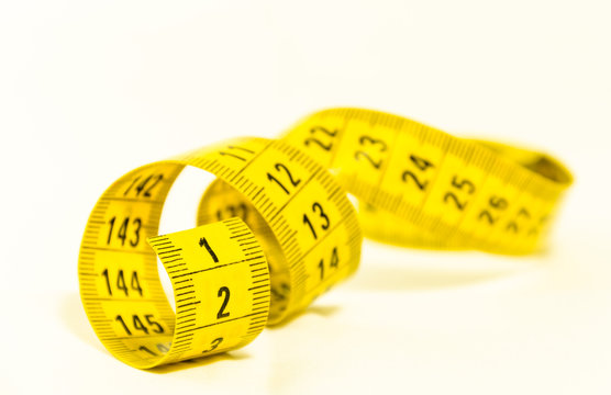 be the first, still life with a yellow tape measure with the number one in the foreground, symbol of success and goal