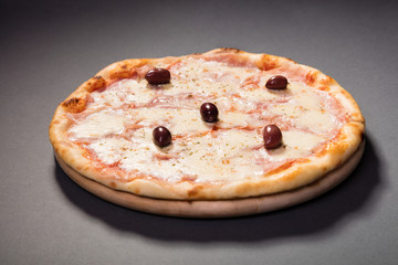 Pizza Vesuvio with mozzarella, tomato sauce, ham, olives... serve