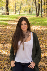 White girl with blue eyes posing in the forest in autumn.