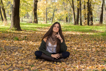 White girl with blue eyes posing in the forest in autumn.